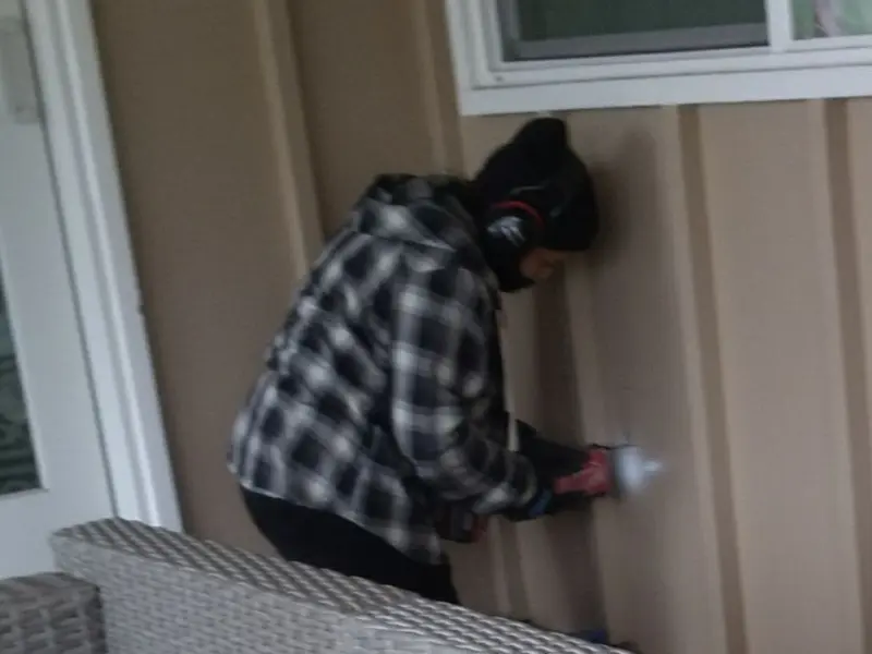 Professional electrician installing an exterior outlet in Durham